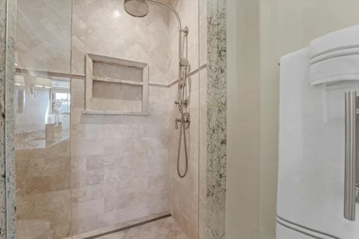 Limestone-tiled shower room