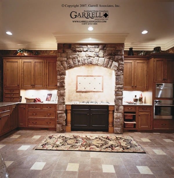 The kitchen includes a cooking alcove highlighted by stone accents.