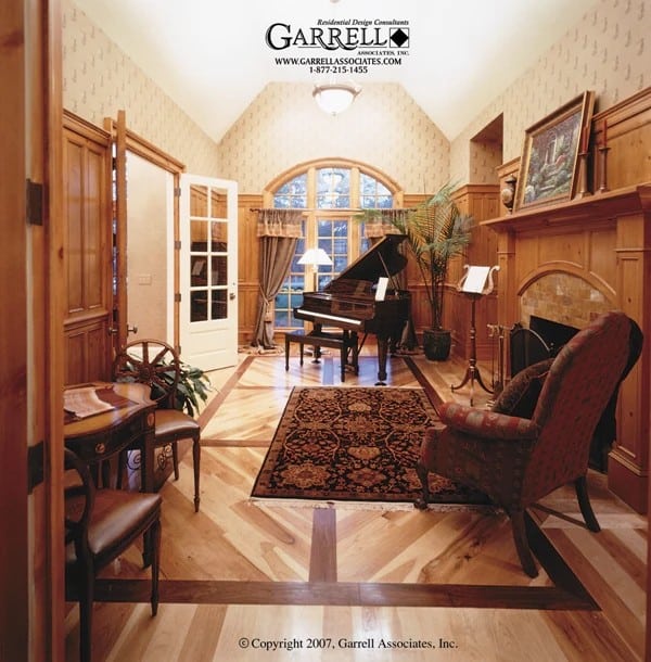 Library with a patterned wallpaper, a baby grand piano, a fireplace, and cushioned chairs.