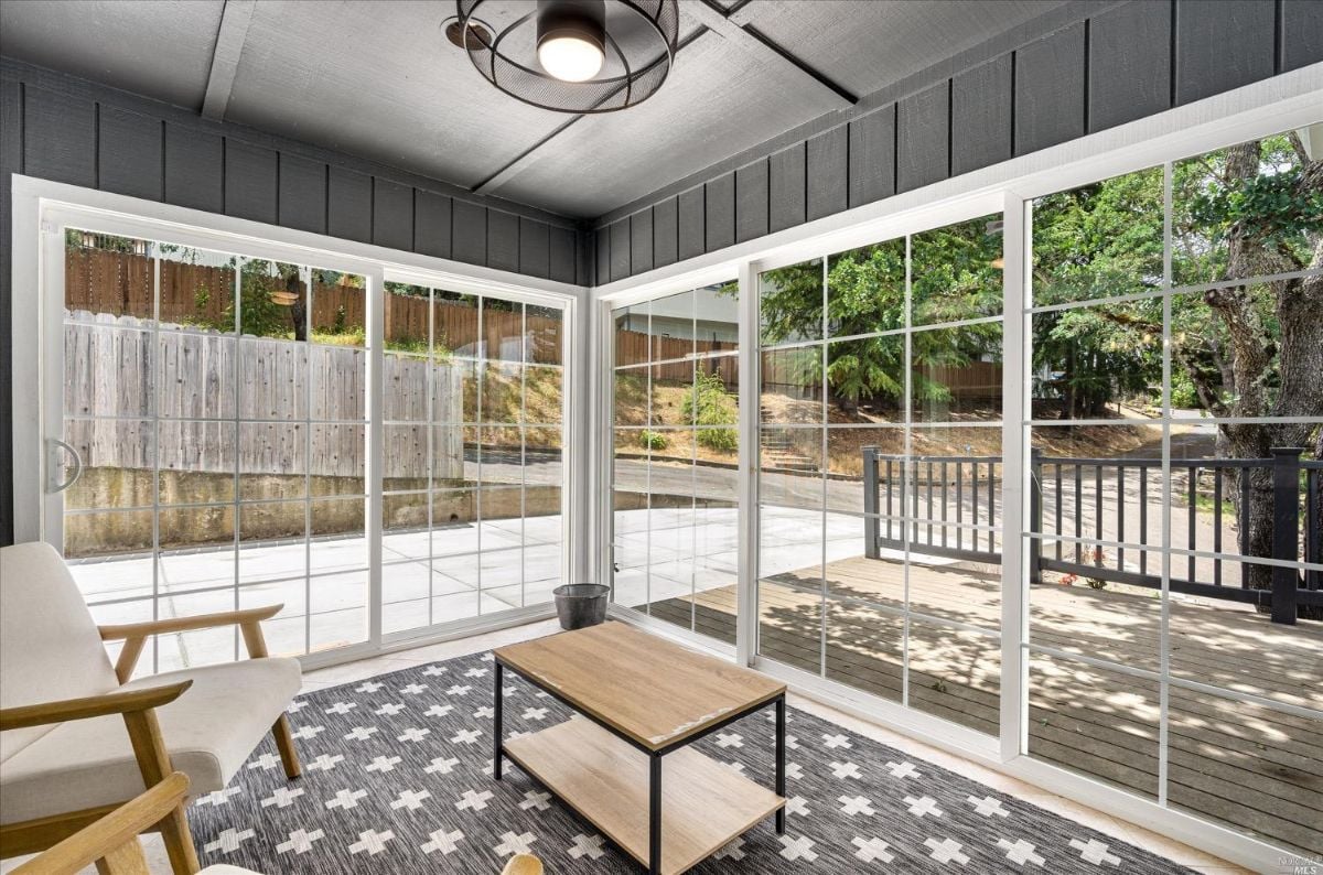 Screened porch with a large screen door.