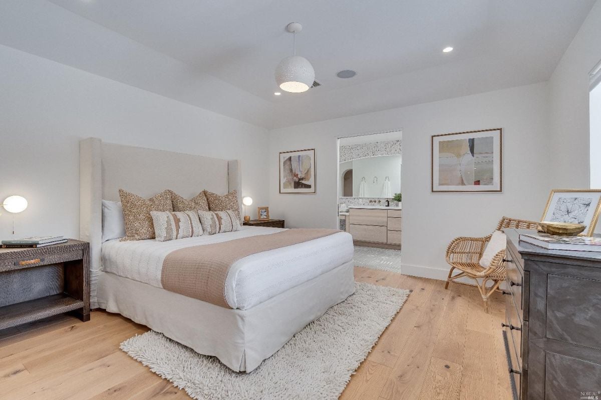 Bedroom with wood floorings and bathroom.