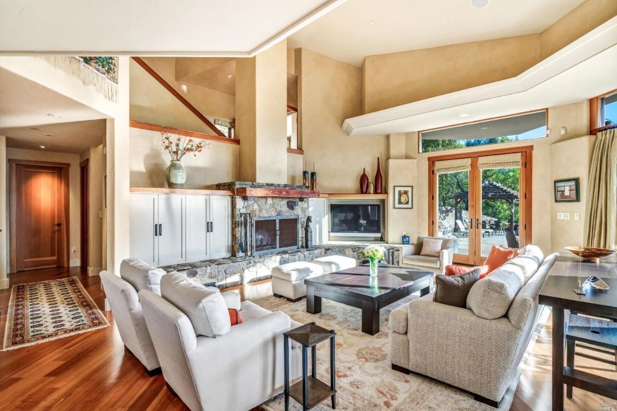 Living room with couches, TV, and fireplace.