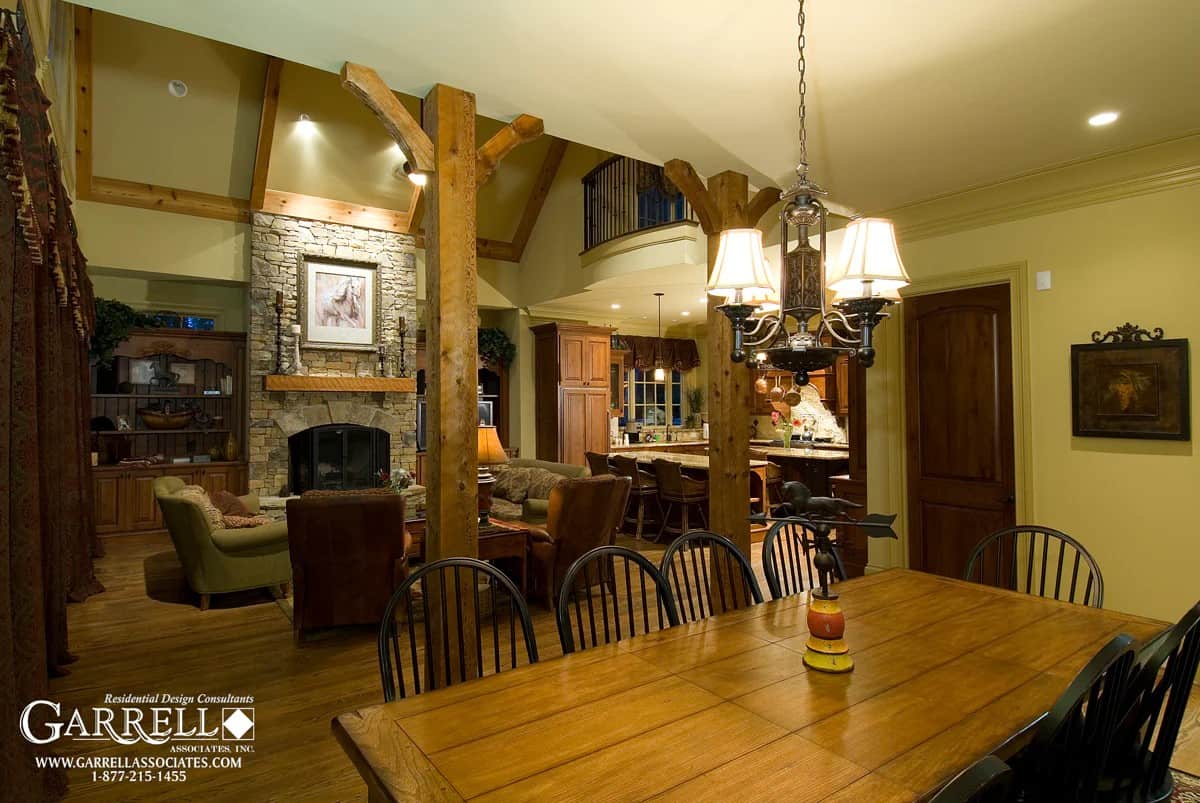 Breakfast room with a wooden dining set well-lit by a warm chandelier.