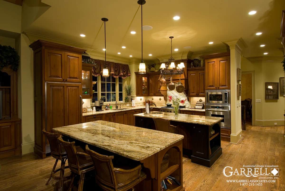 Kitchen with natural wood cabinetry, granite countertops, and two islands.