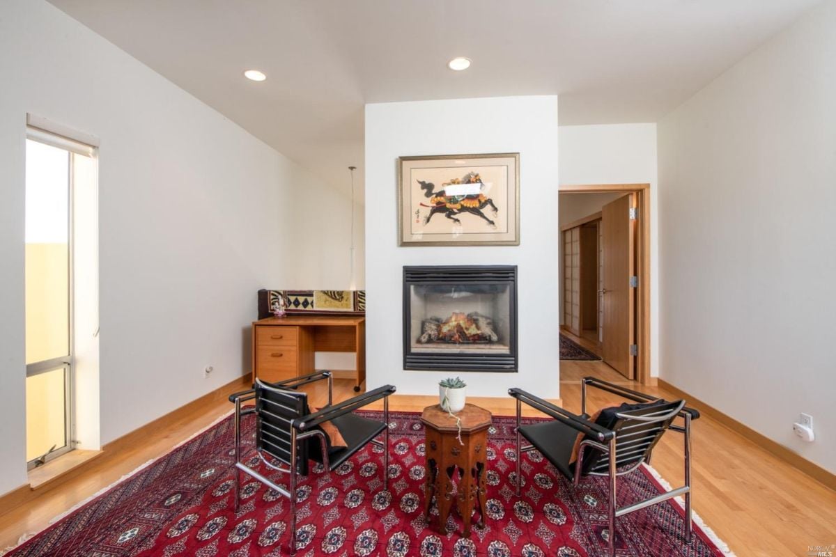 Living room with a rug and fireplace.