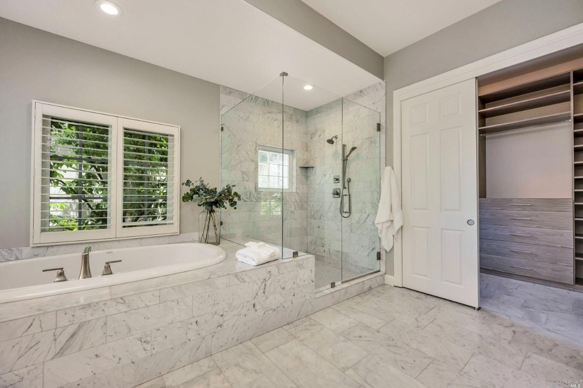 Bathroom with bath tub, shower, and walk-in closet.