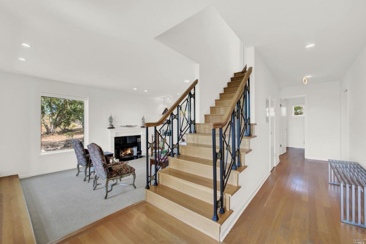 Staircase near the living room leading to the second level of the house.