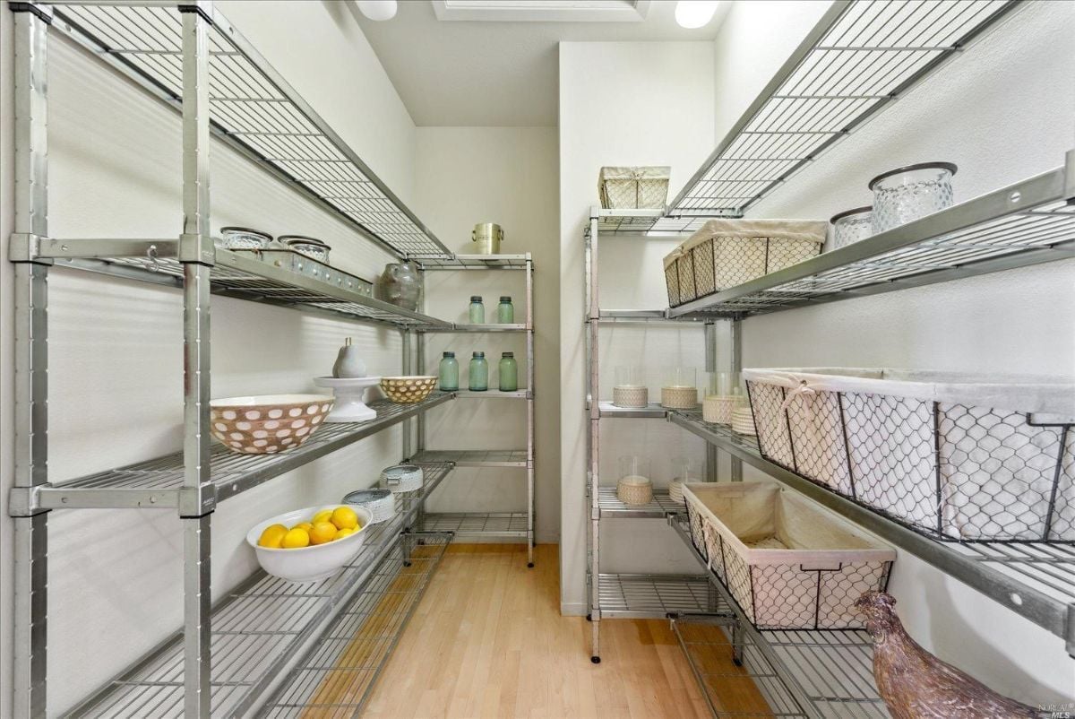 Pantry with a long row of shelves.