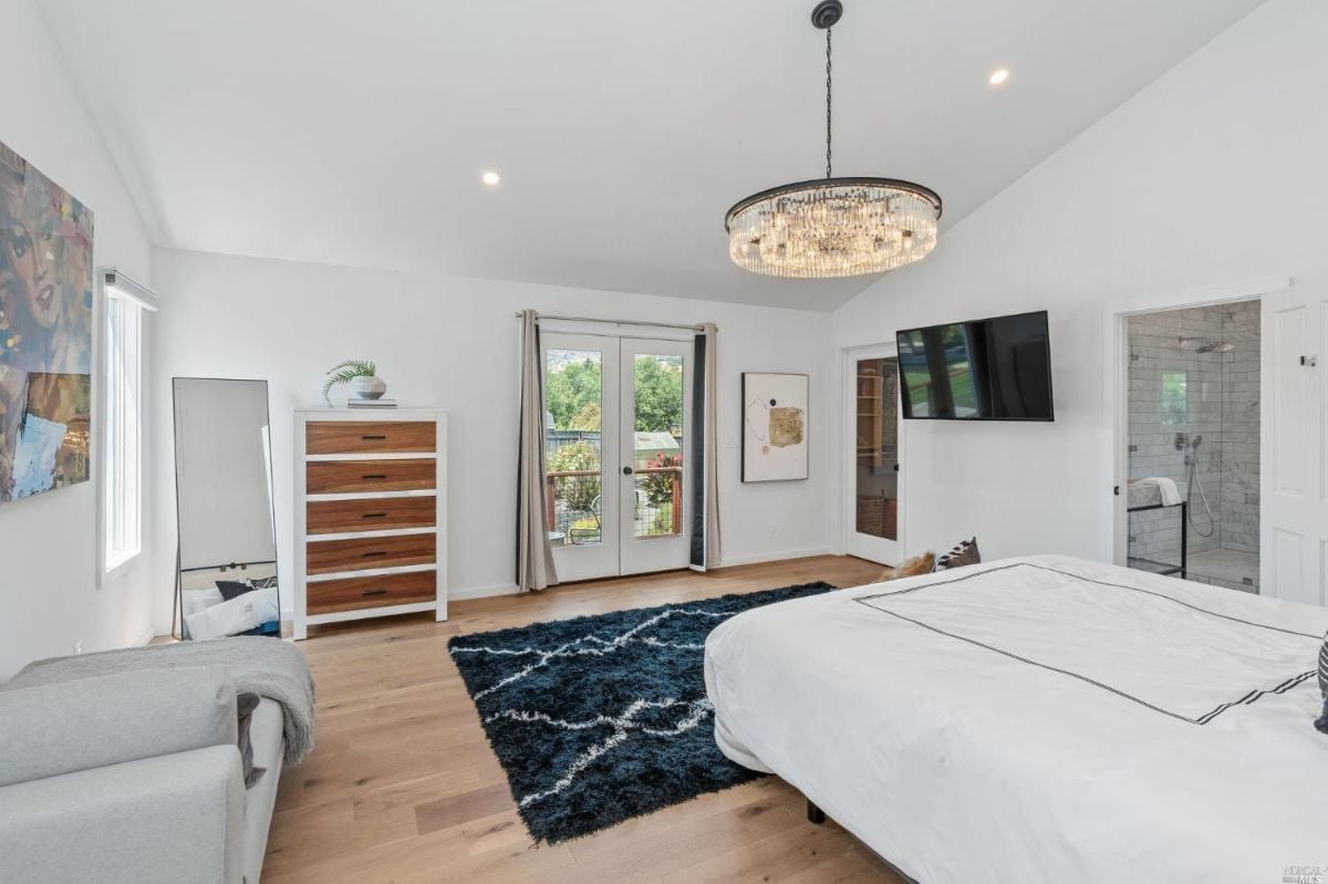 Bedroom with a television and glass doors.