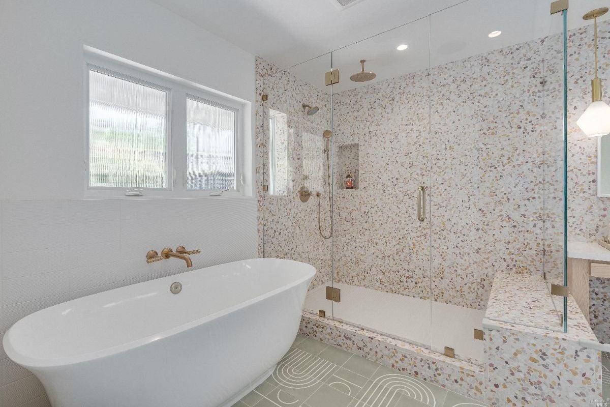 Bathroom with a huge bath tub and shower.
