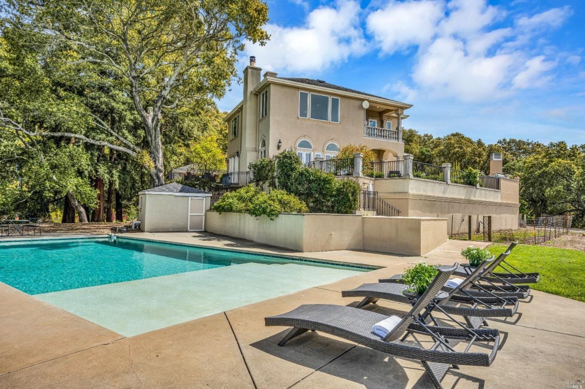 Rear view of the mansion with a pool.