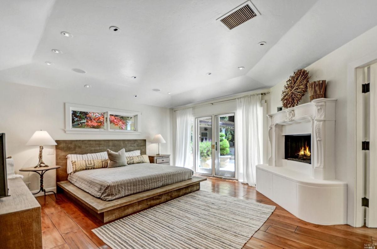 Spacious bedroom with fireplace.