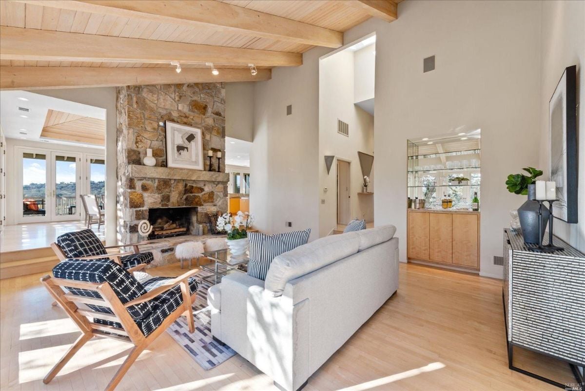 Living room with chairs and fireplace.