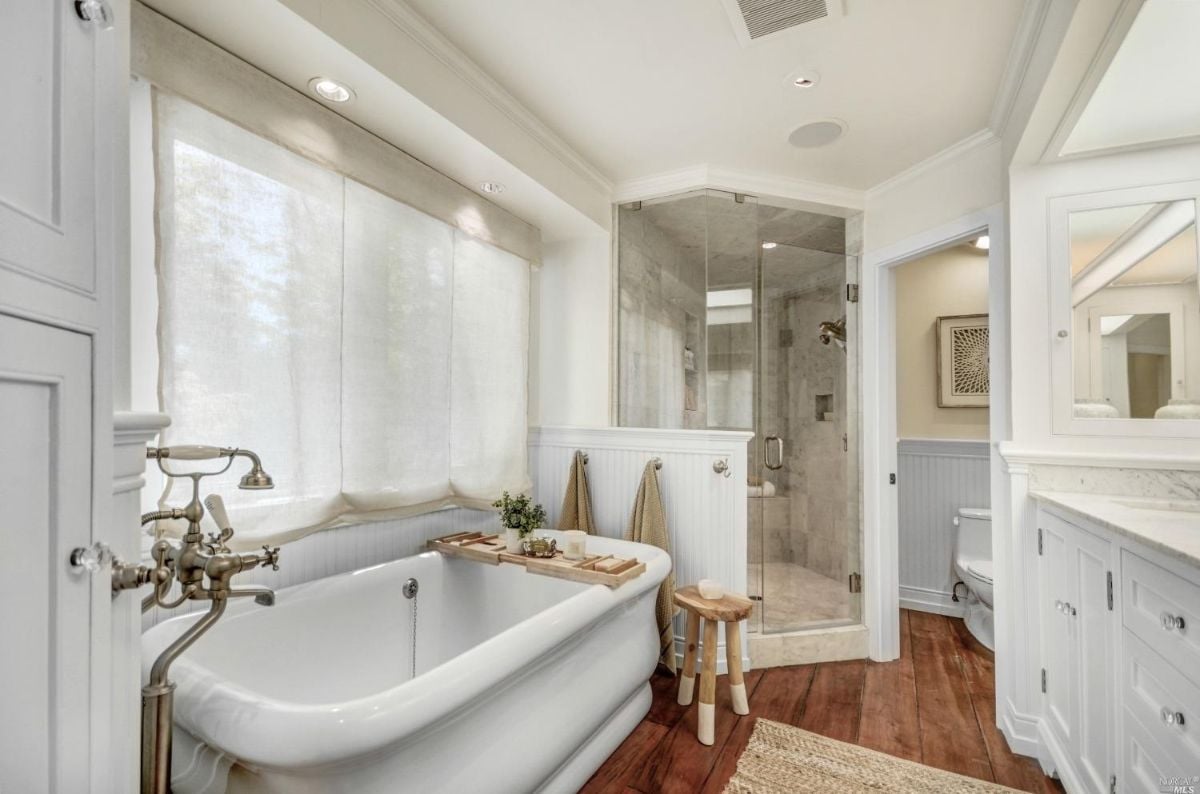 Bathroom with bath tub, sink, shower, and toilet.