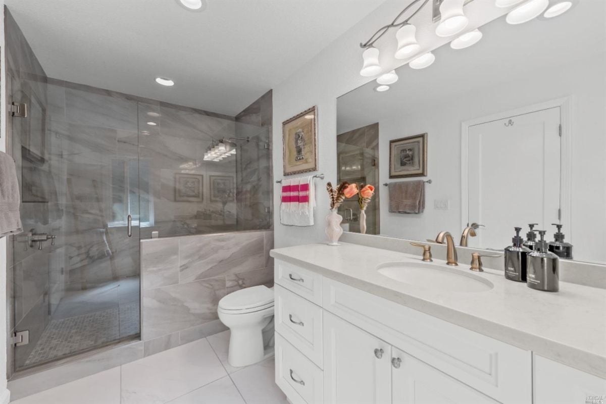 Bathroom with sink, shower and toilet.