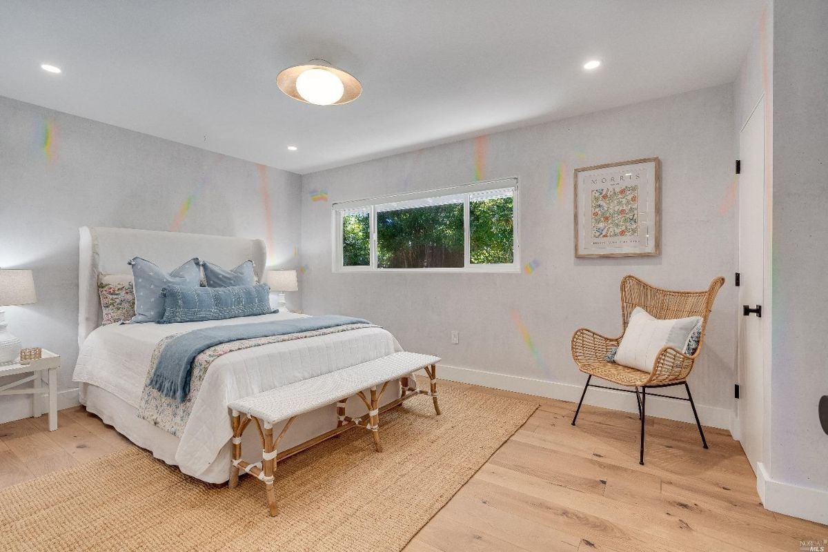 Bedroom with wood floorings and glass windows.