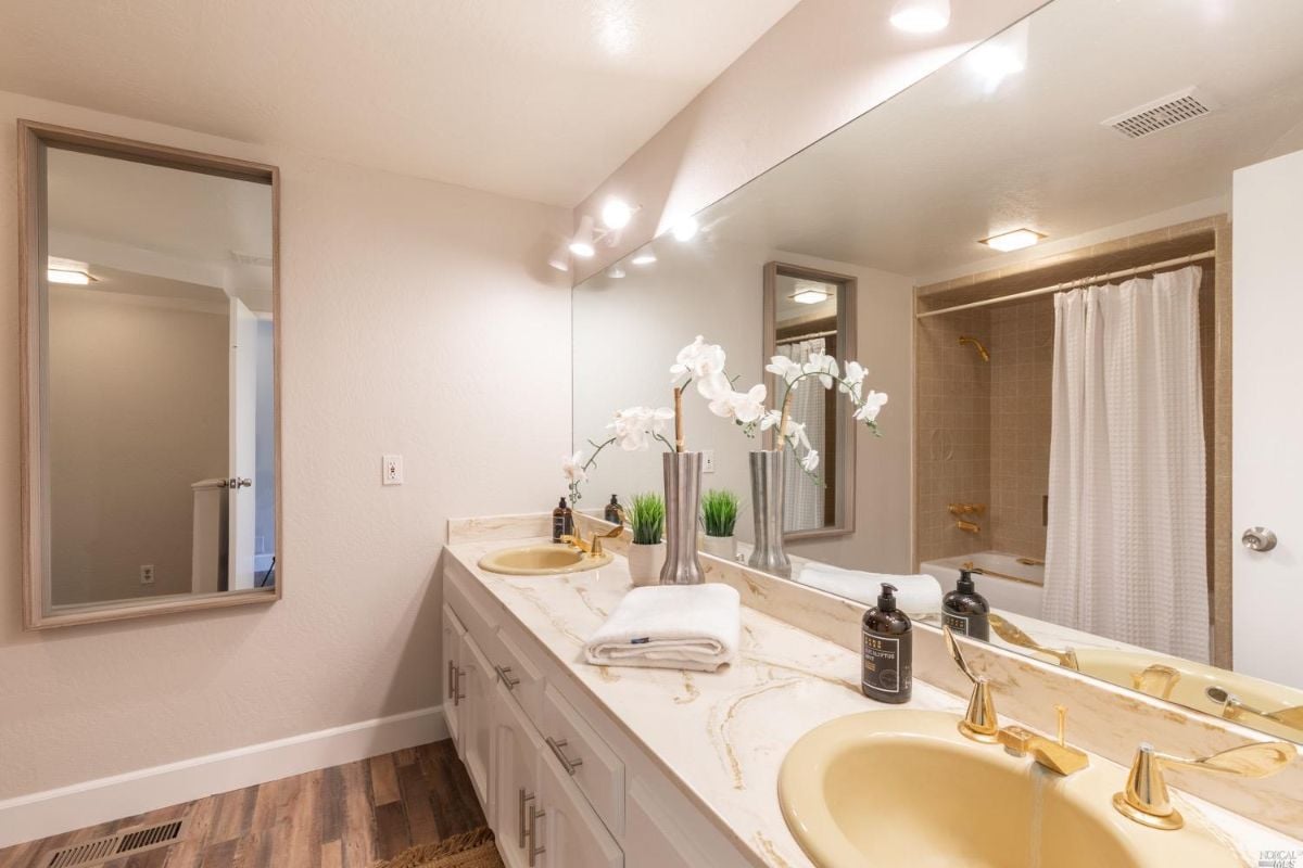 A well-lit bathroom with a sink and mirror