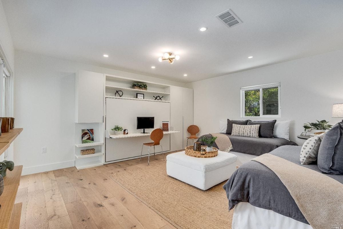 Living room with wood floorings and glass windows.
