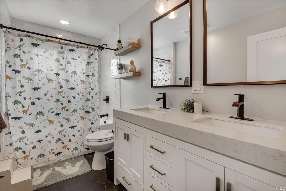 Bathroom with sink, shower, and toilet.