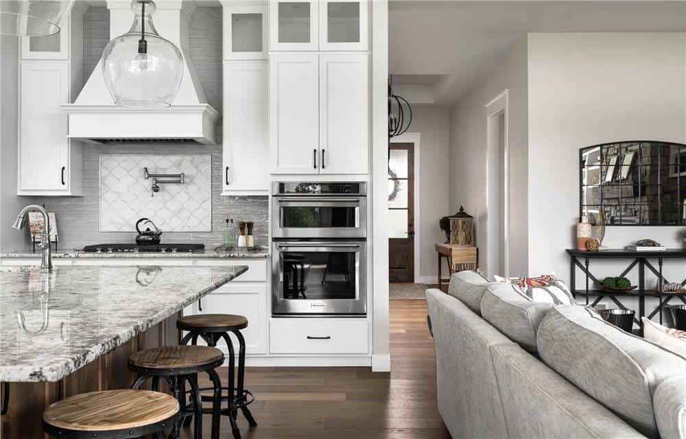 Great room and kitchen with hardwood flooring and a view of the foyer.