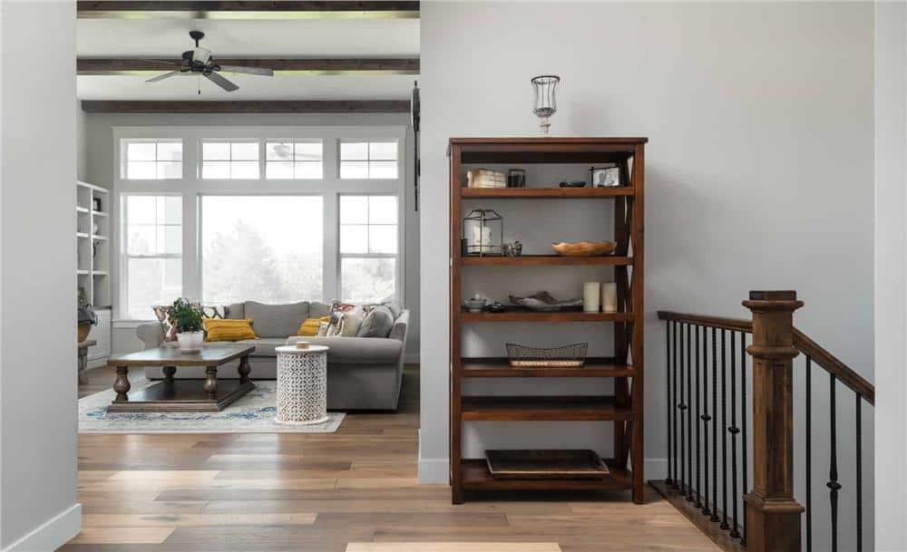Entry with a staircase leading down to the basement and a view of the bright great room.