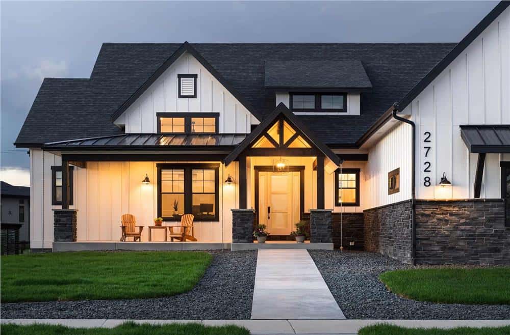 Covered entry porch with dormer windows and stone base columns.