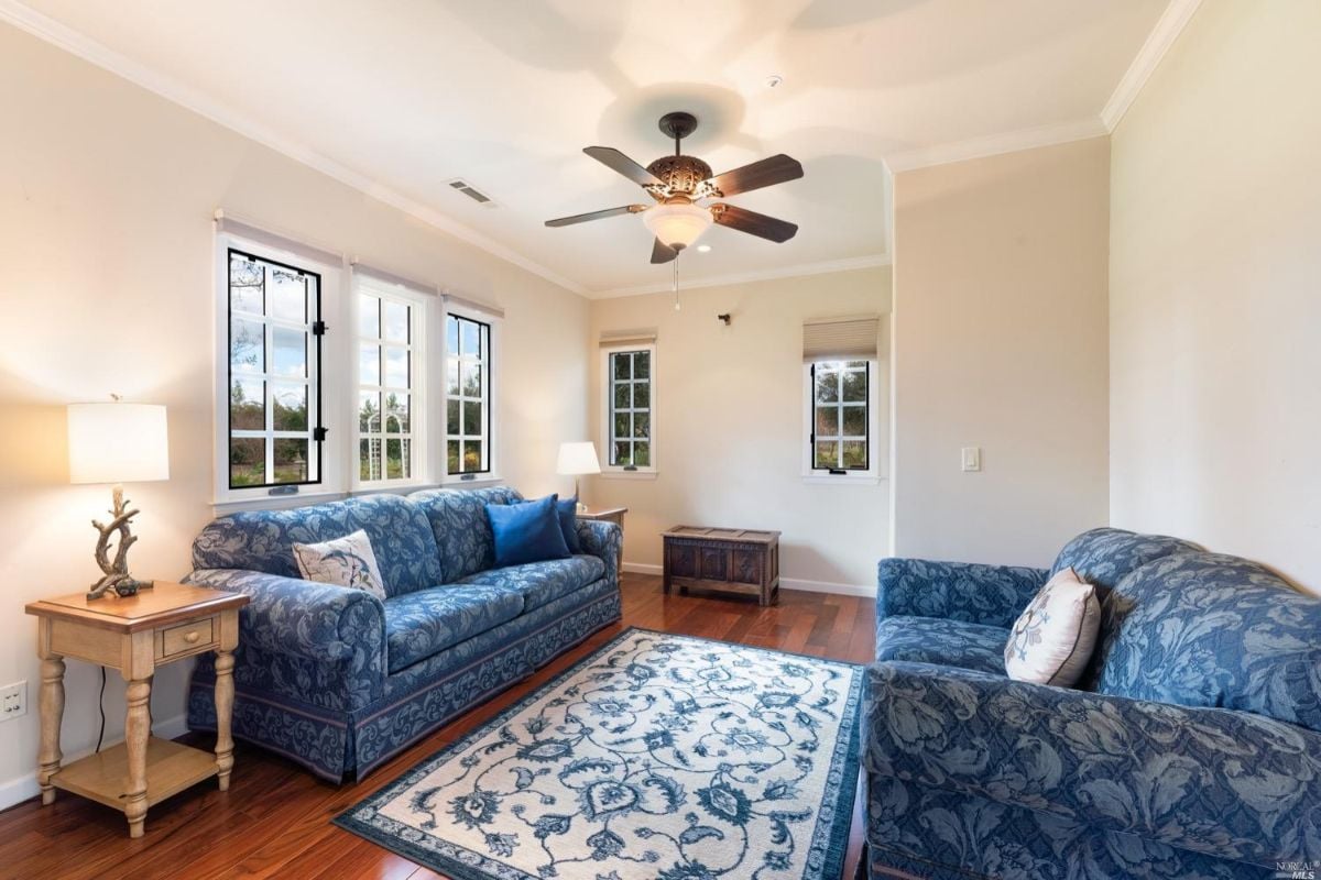 Living room with wood floorings and couches.