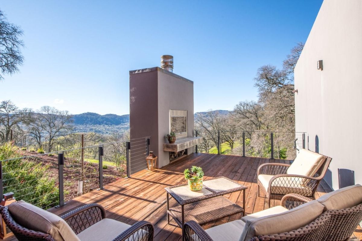 Patio on a wooden deck with a view of the mountains.