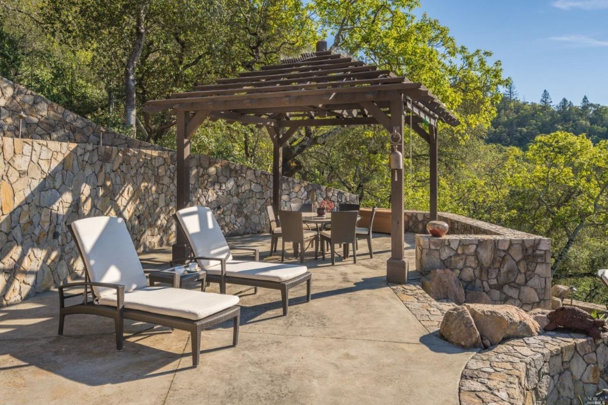 Patio with a gazebo and lounge chairs.