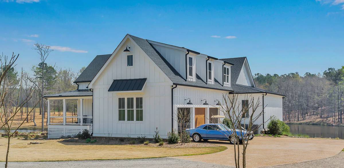 Front-right view of the house with shed dormers and a 2-car side-loading garage.