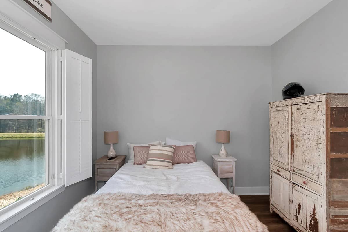 A large picture window provides this bedroom with stunning views.