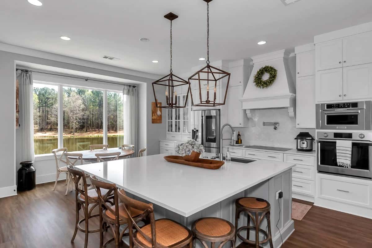 The kitchen features modern appliances and a large center island with bar seating.