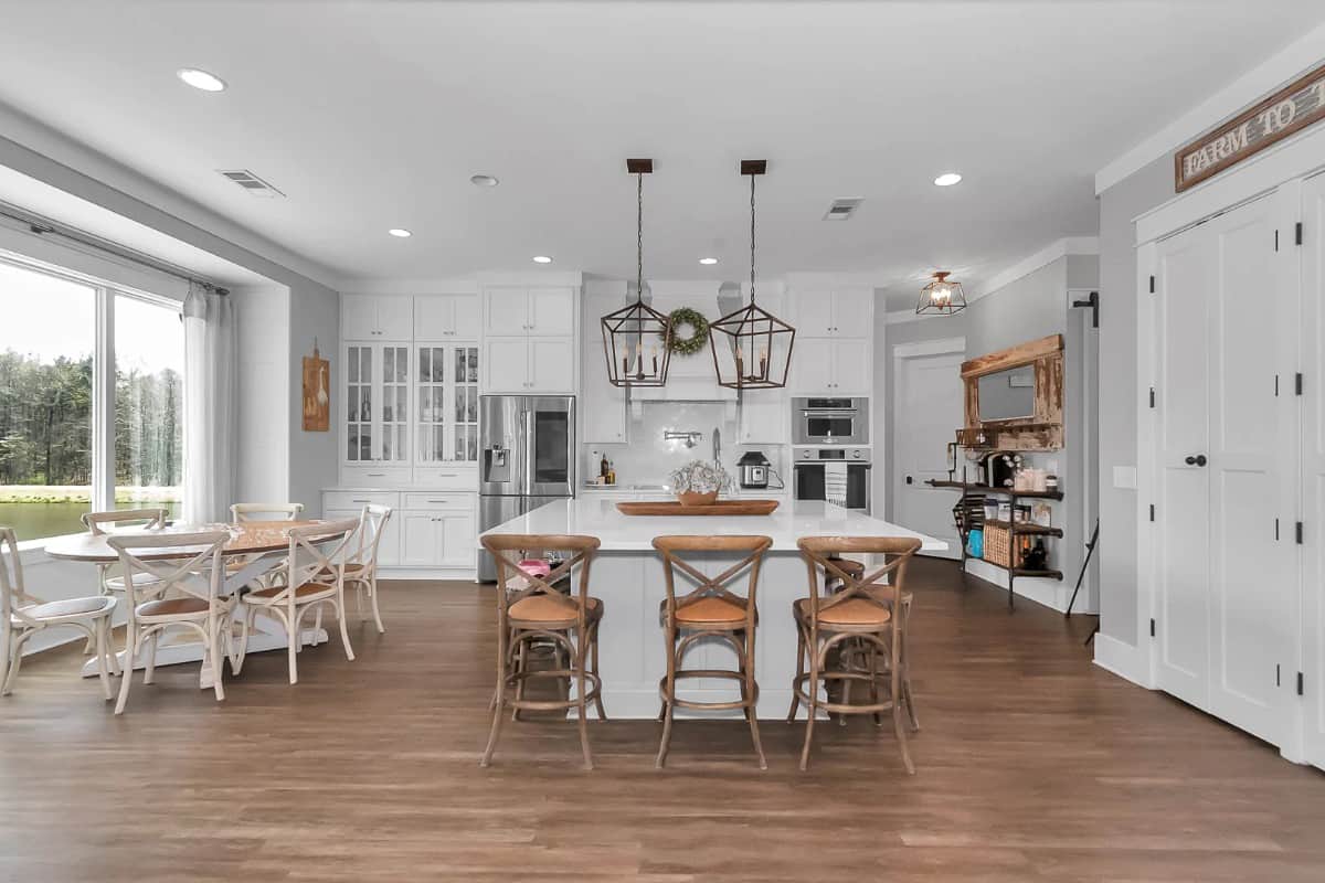Recessed ceiling lights and a couple of pendants suspended over the island illuminate the kitchen.