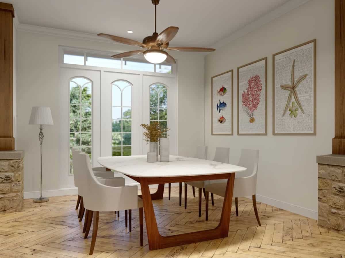 Formal dining room with tall arched windows, a contemporary dining set, and framed artworks adorning the white walls.