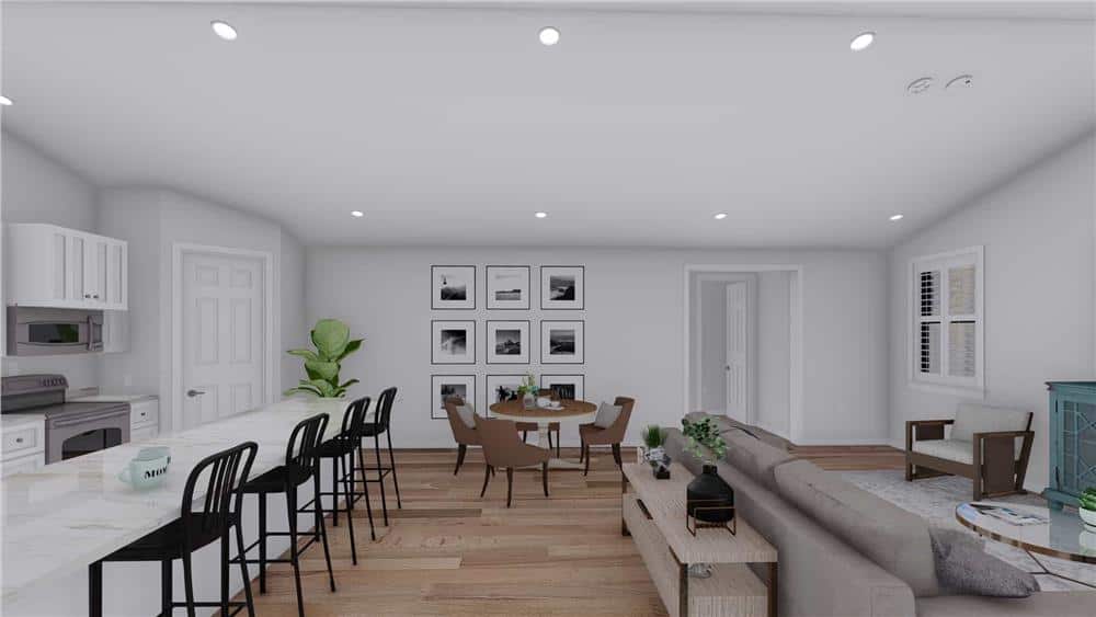 An open layout view of the great room, kitchen, and dining area highlighted by a gallery wall.