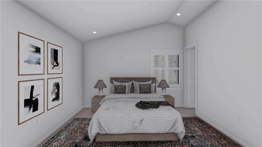 The primary bedroom has a vaulted ceiling and a louvered window that invites natural light in.