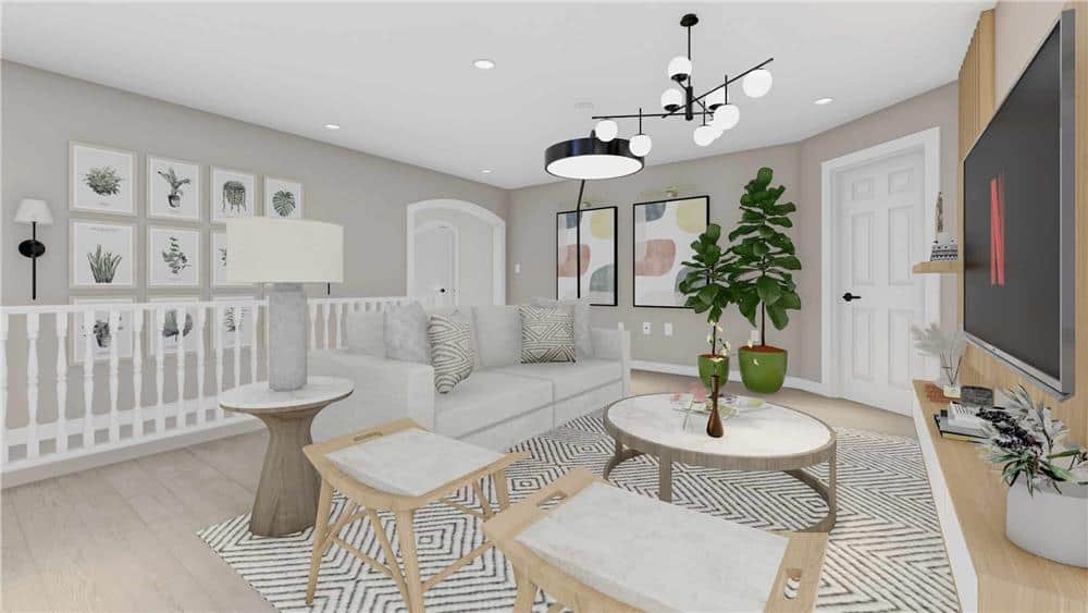The family room has contemporary seats, round tables, and a wall-mounted TV.