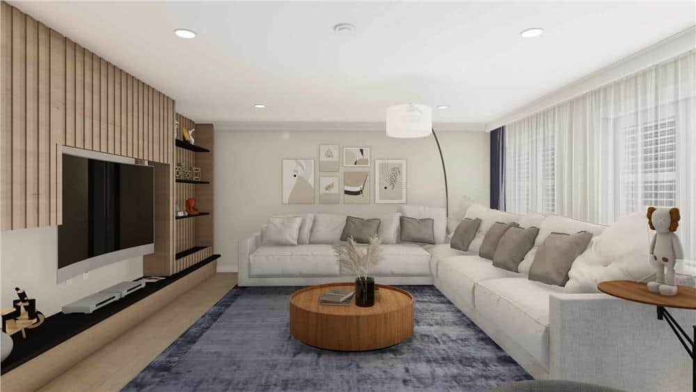 Lower-level family room with a large TV and an L-shaped sofa paired with a round coffee table.