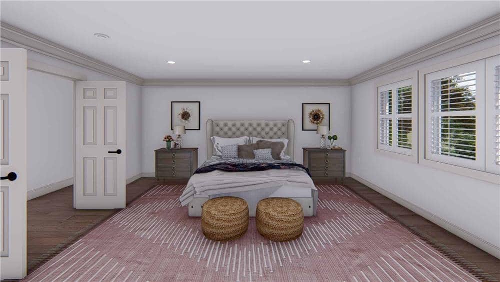 Primary bedroom with dark wood nightstands and a wingback bed complemented with wicker footstools.