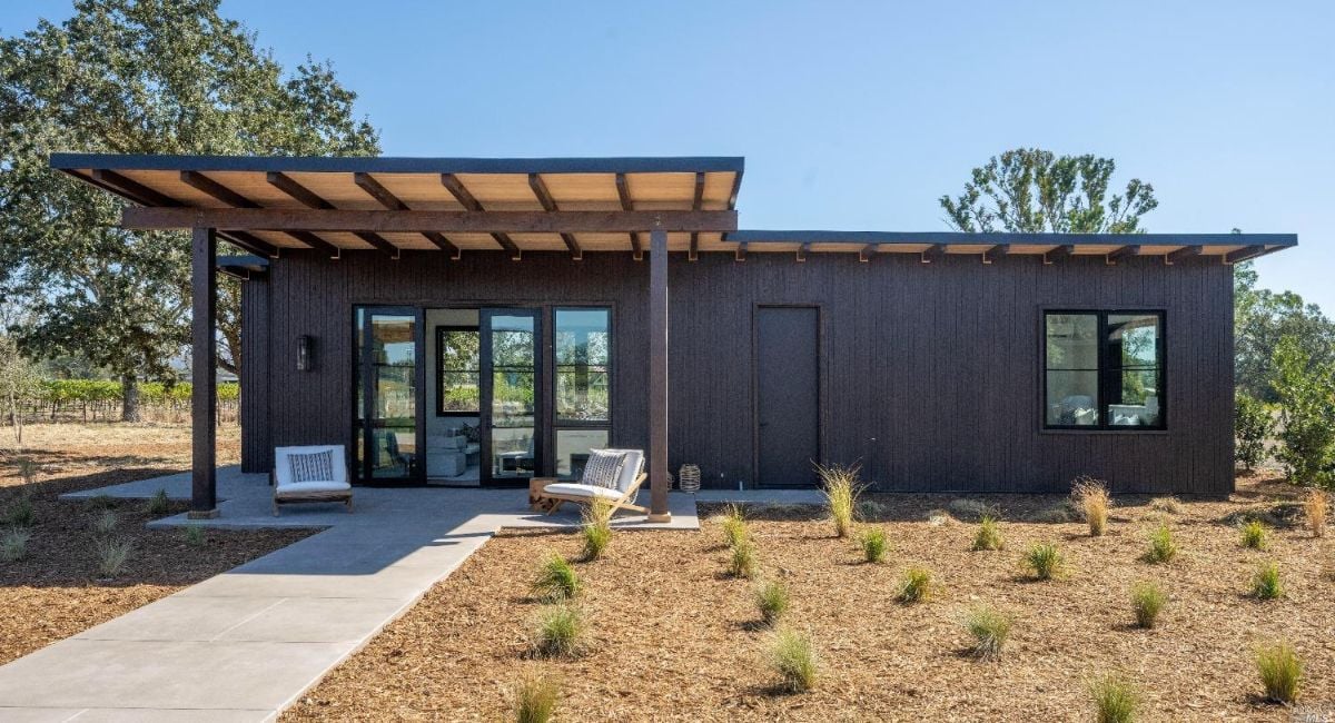 Guest house with sliding glass doors and glass windows.