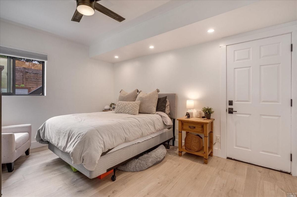 Bedroom with a large bed and a ceiling fan.