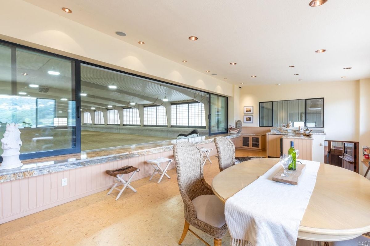 Large barn with a dining table and sink for staff or guest.