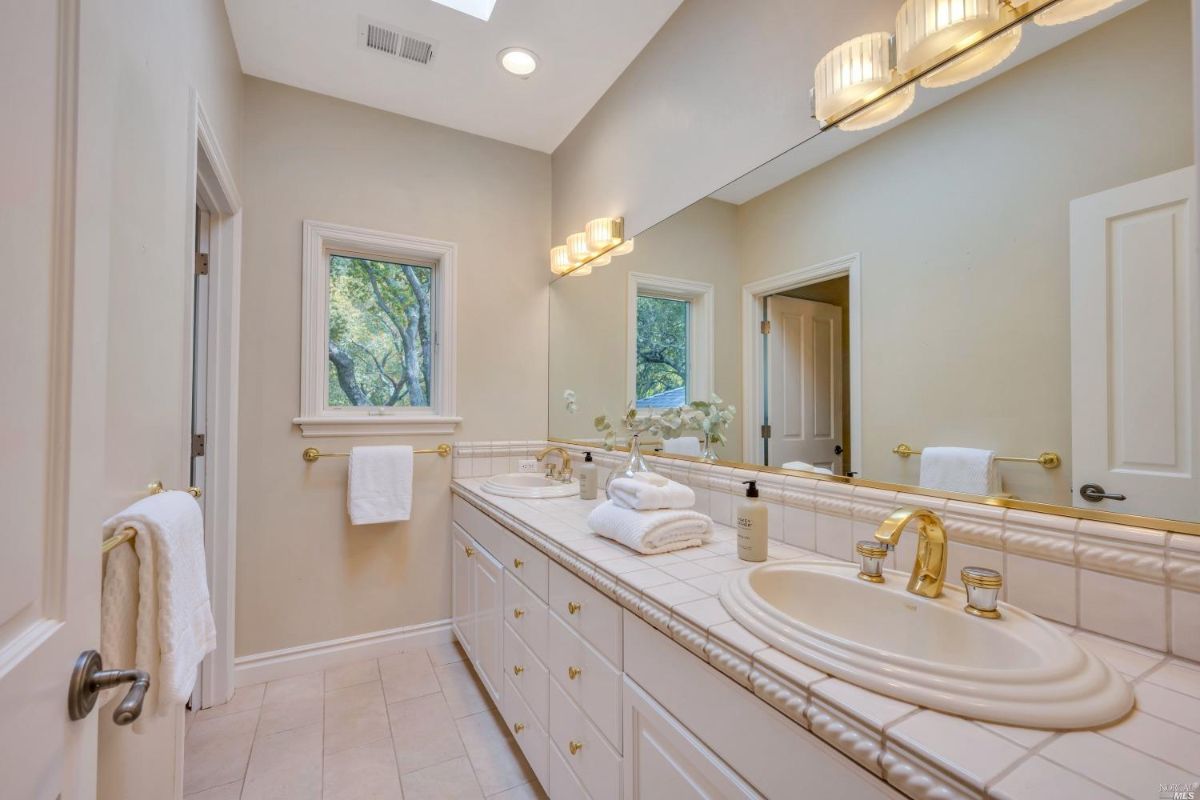 Bathroom with sink and a large mirror.