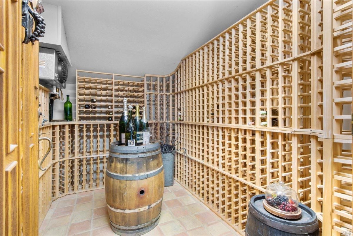 Wine cellar with wooden shelves and barrels.