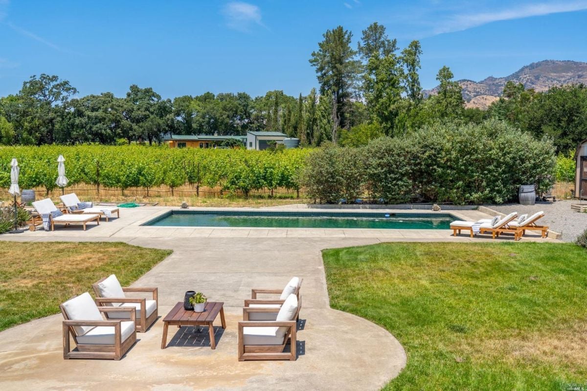 Backyard pool with lounge chairs.