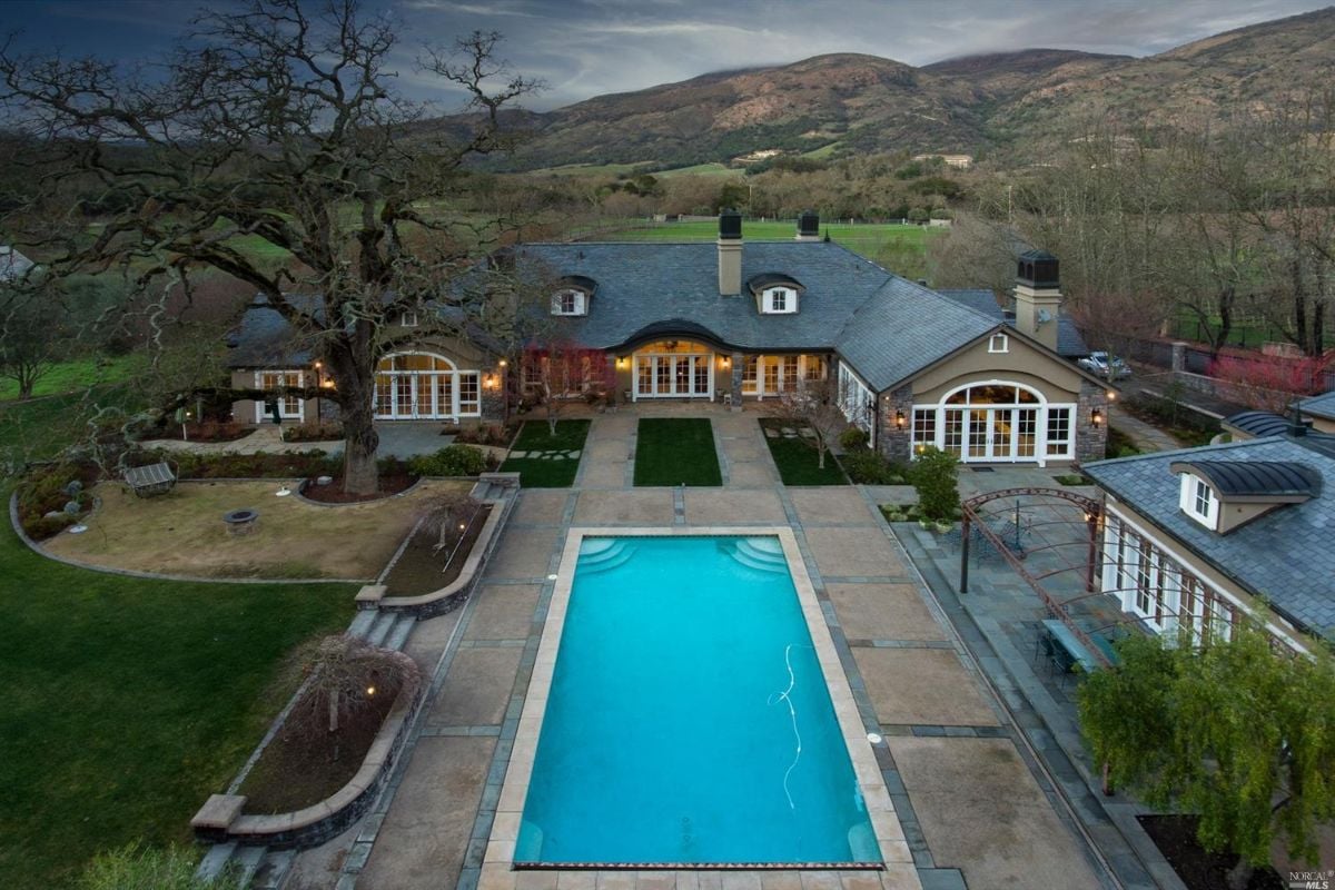 Aerial view of the mansion's pool with a mountain view.