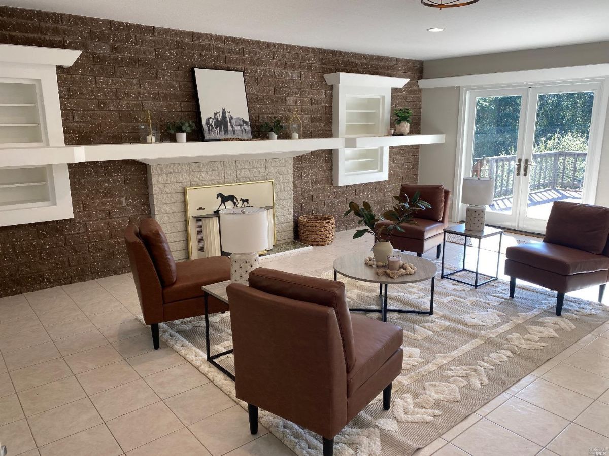 Living room with a fireplace and chairs.