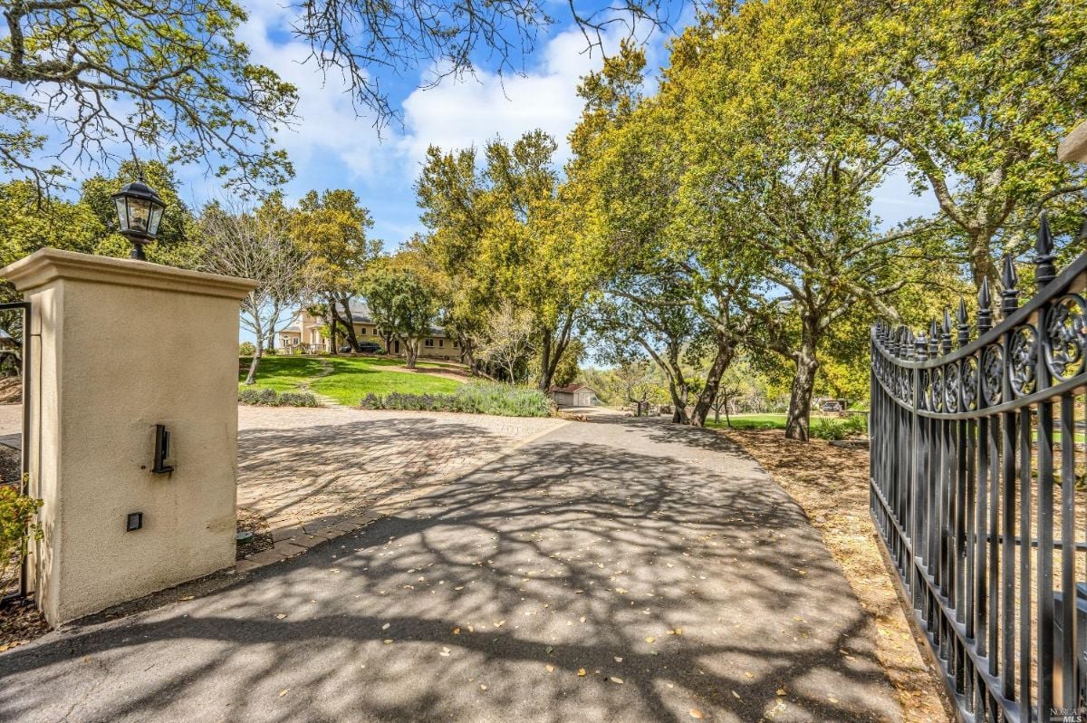 Main gate with a paved driveway.