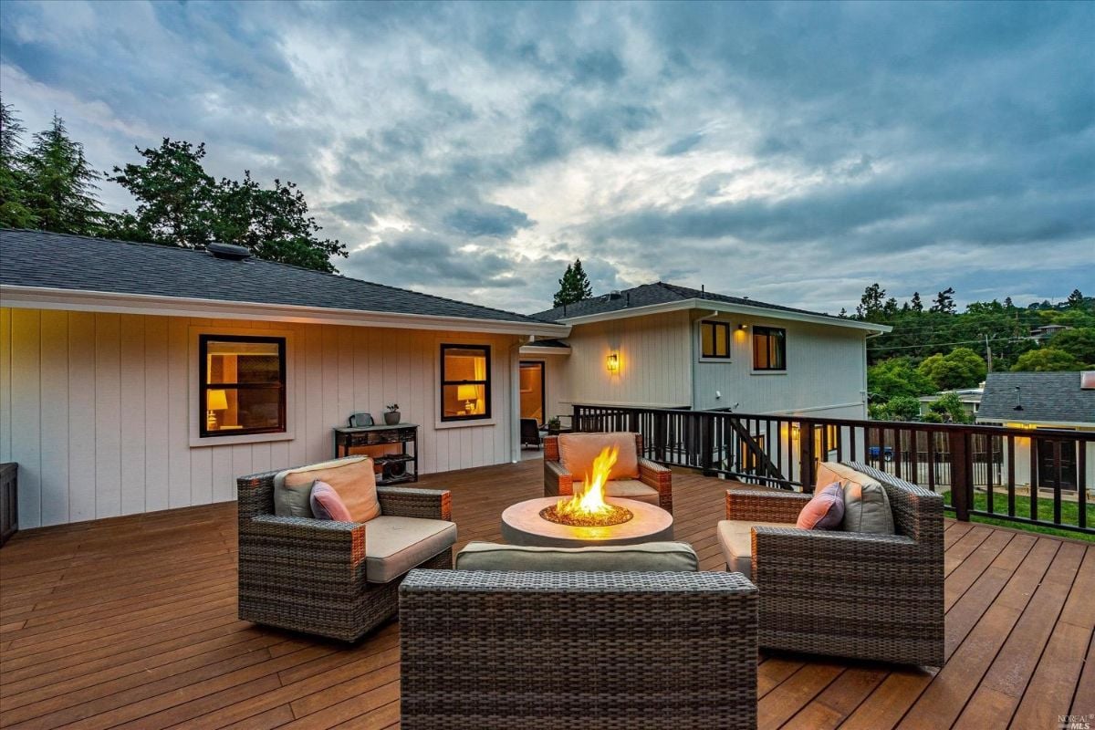 Patio with chairs and fire pit.