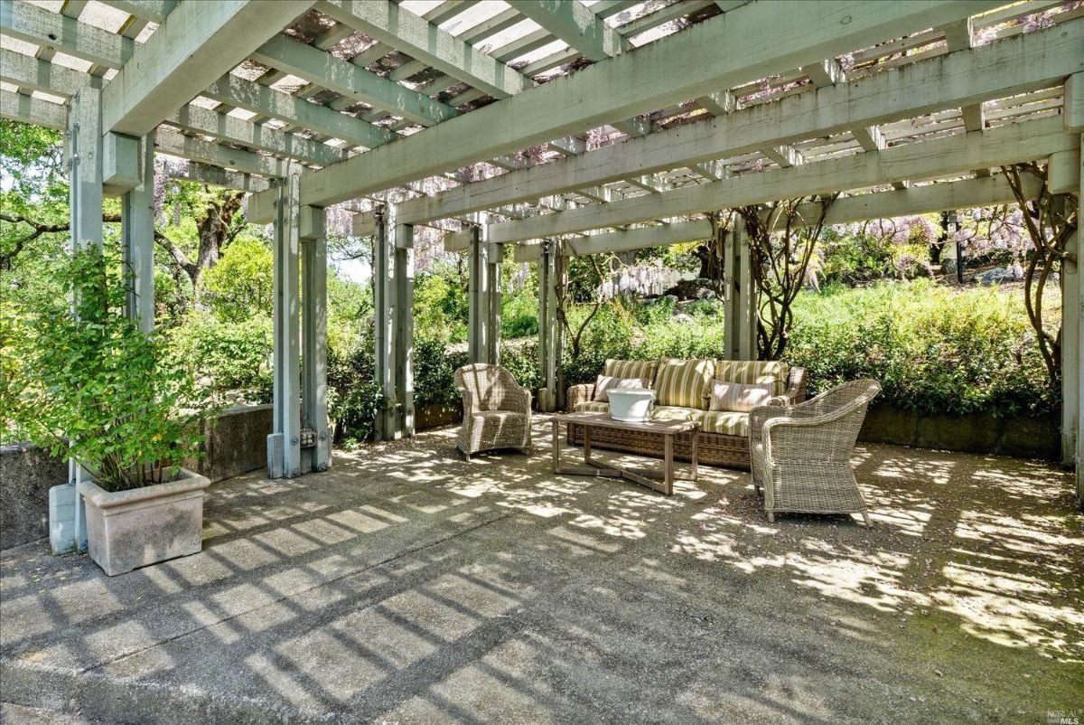 Pergola with table and chairs.